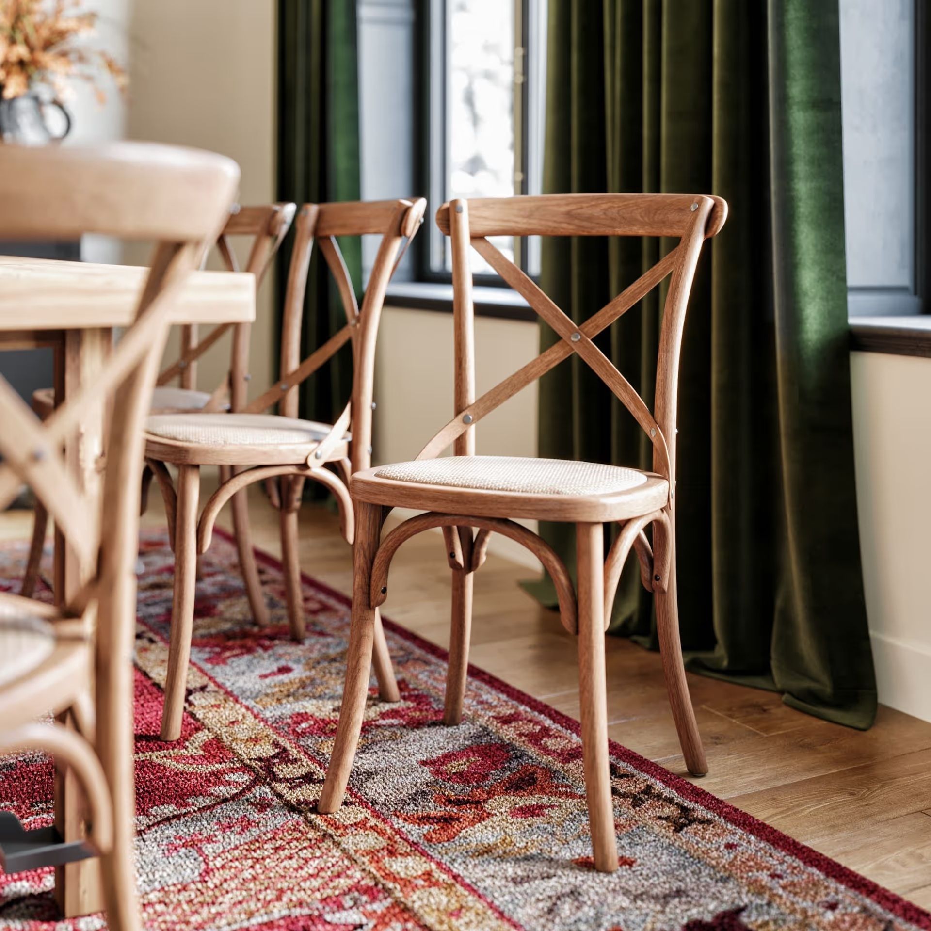 Product rendering close-up of a wooden chair in a styled dining room with warm lighting and detailed textures.