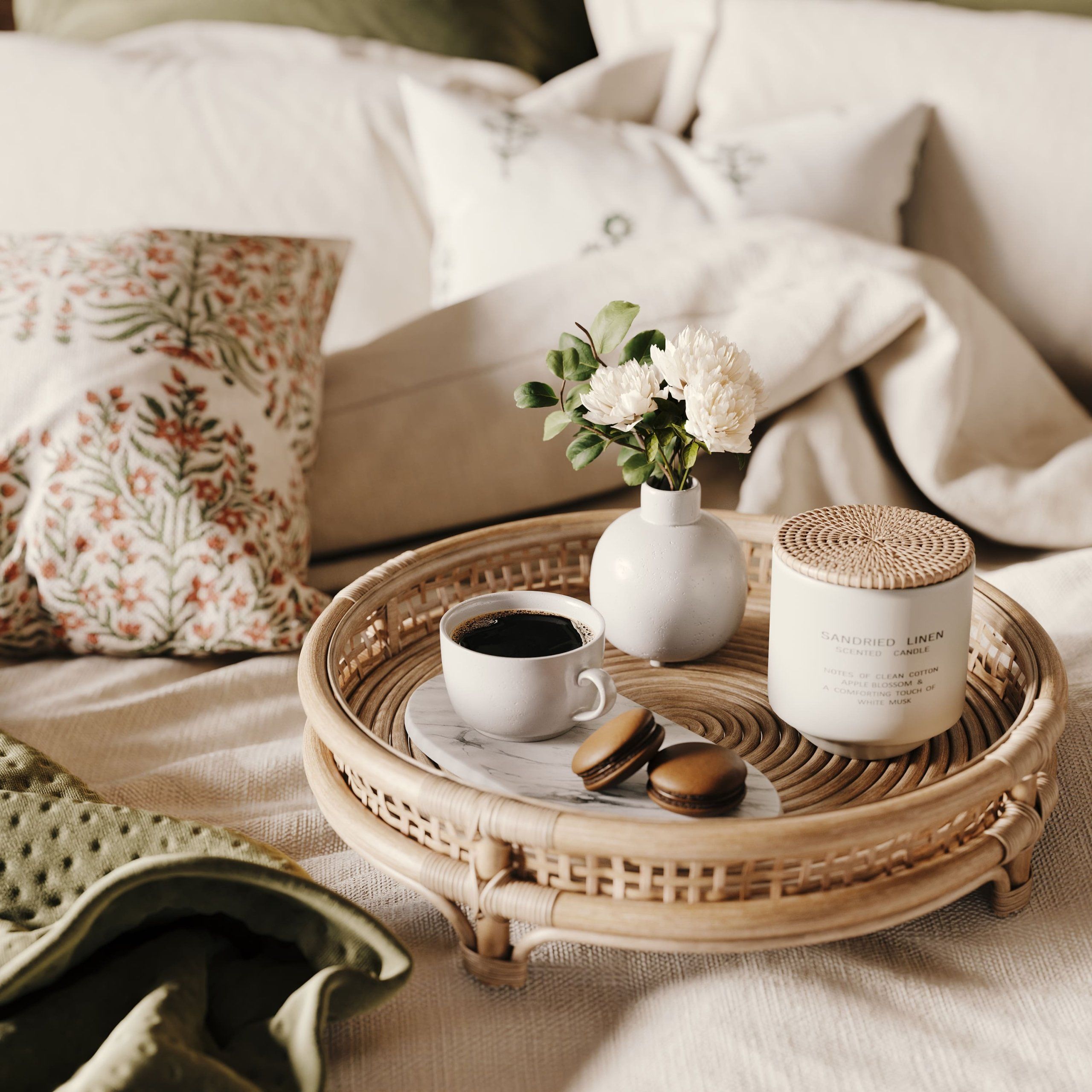 3D rendered image of a cozy bedroom scene featuring a texstiles, tray with coffee, macarons, and flowers