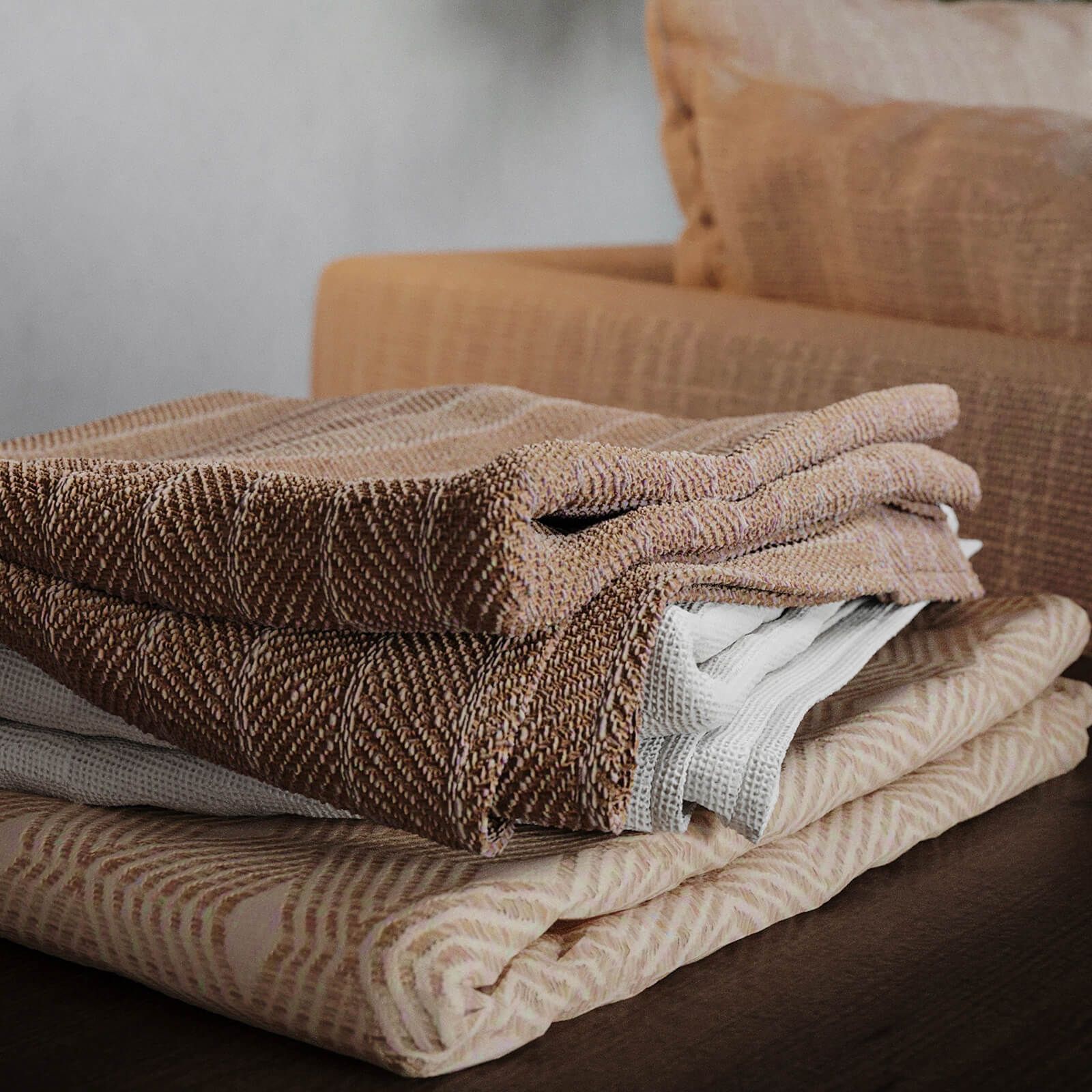 High-quality photorealistic 3D rendering of folded textiles on furniture, showcasing 3D furniture modeling and visualization.