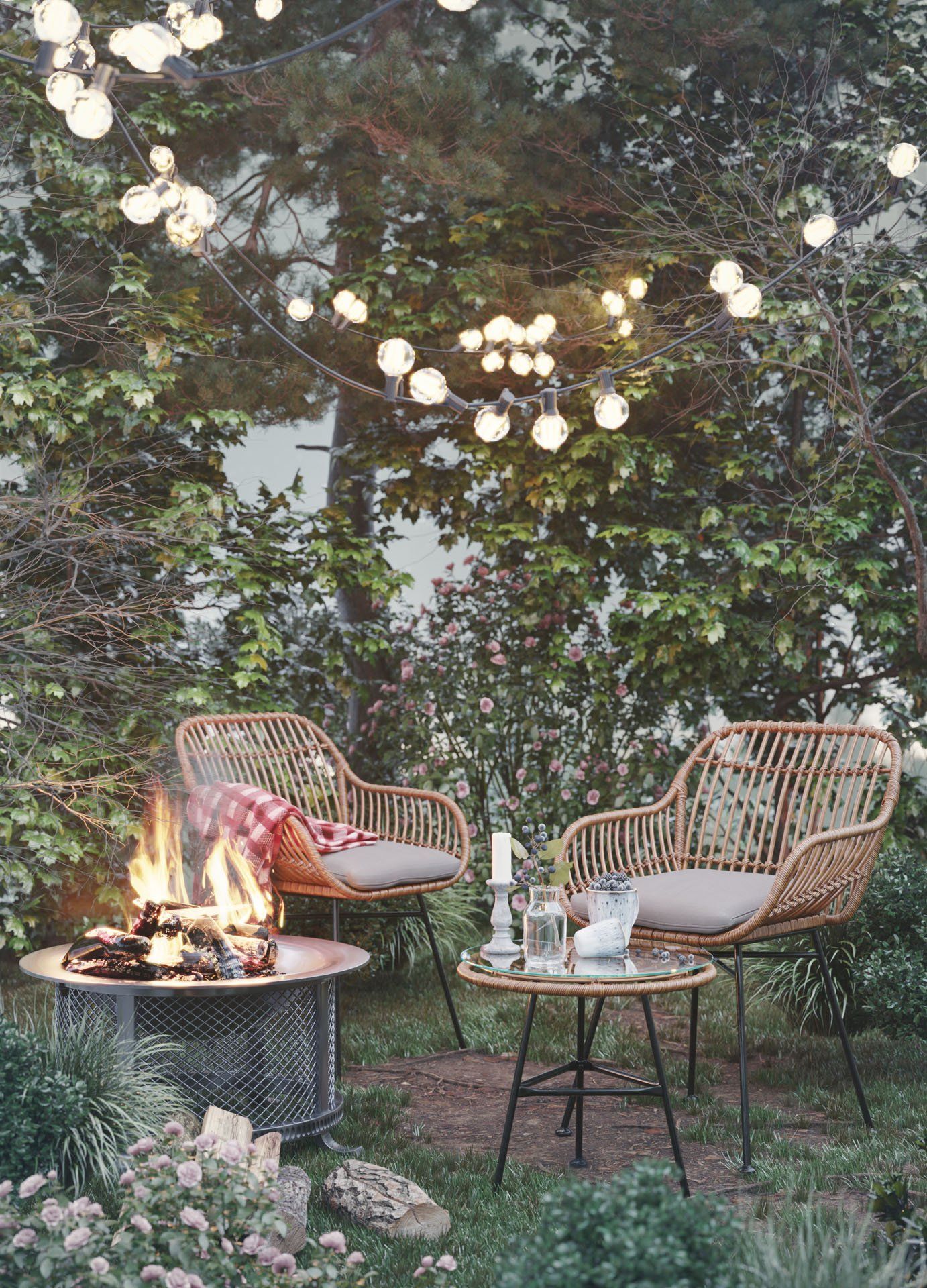 3D lifestyle visualization featuring rattan chairs and a fire pit in a garden setting