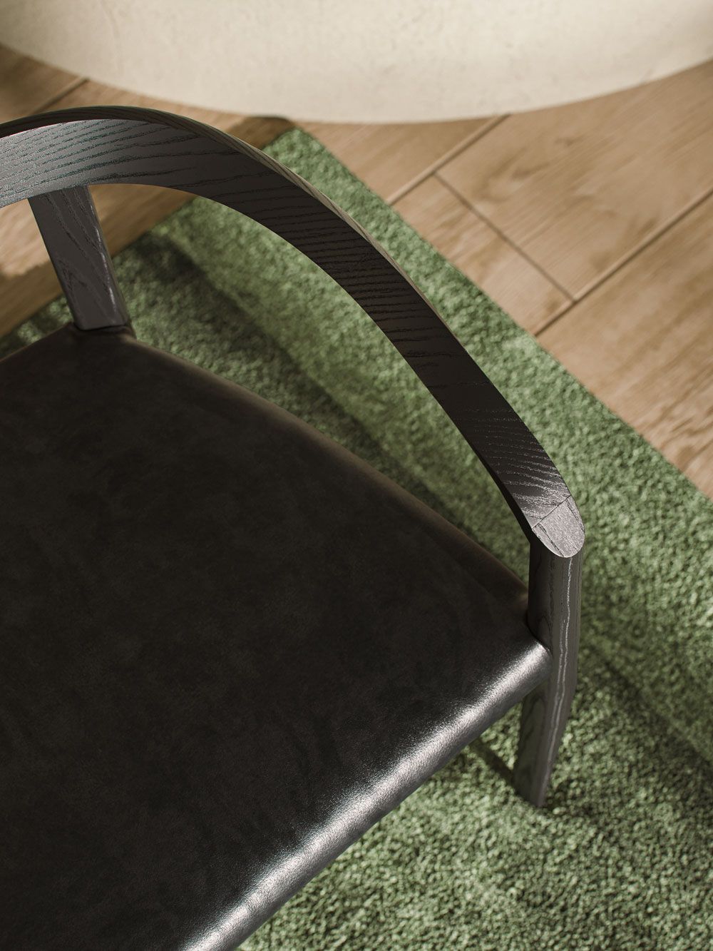 Top view of a realistic 3D rendered chair on a green rug