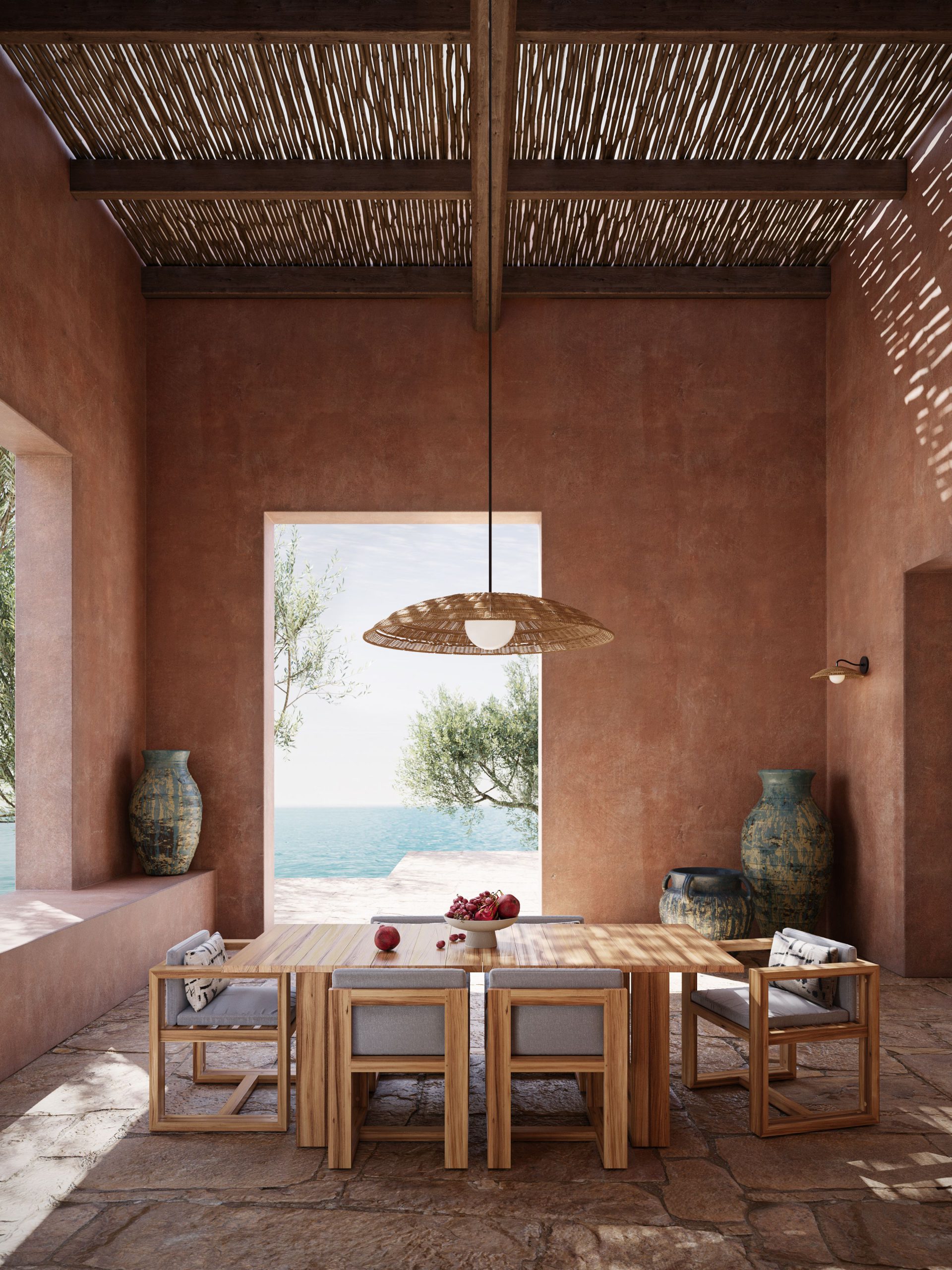 3D rendering of a woven rattan pendant light above a teak dining set in a terracotta-walled Mediterranean dining space with bamboo ceiling, ceramic vases, and ocean view