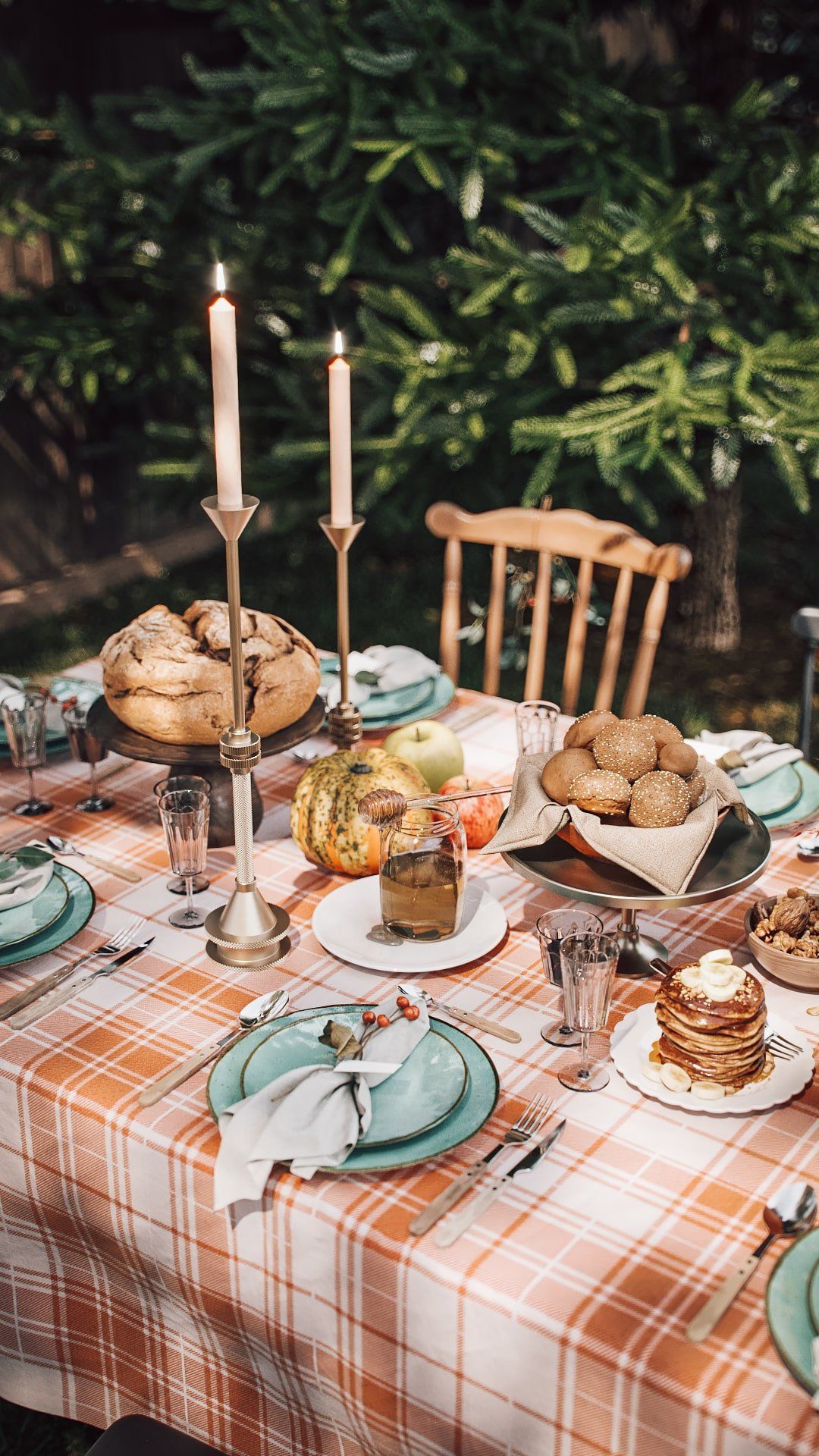 3D rendered image showcasing a dining table with a plaid tablecloth, candles, and various food items